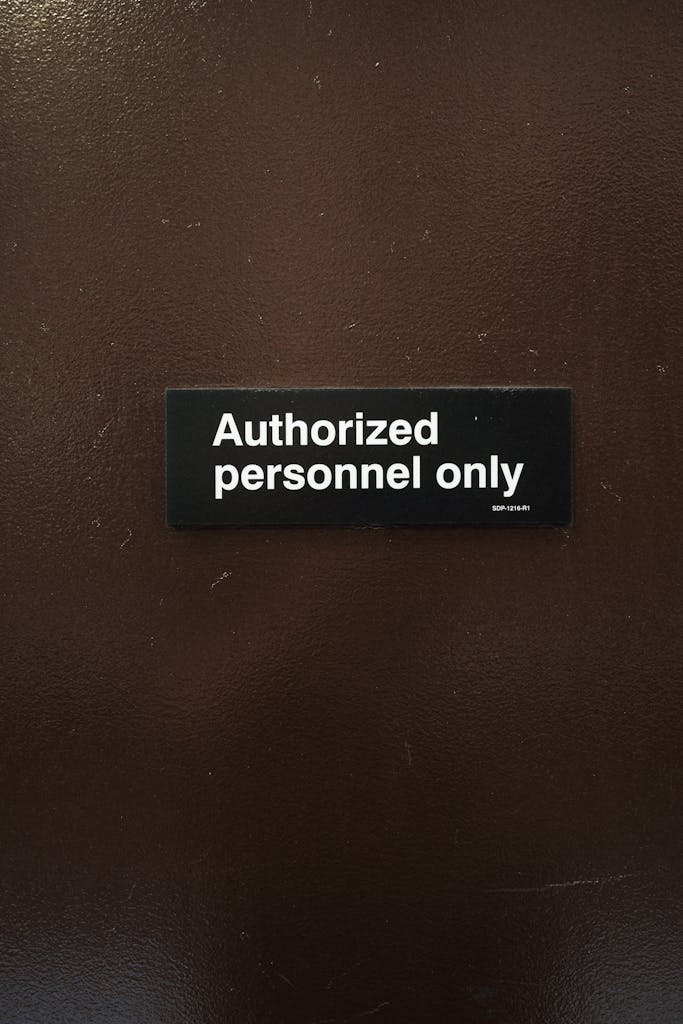 Close-up of an 'Authorized personnel only' sign on a brown door, indicating restricted area.