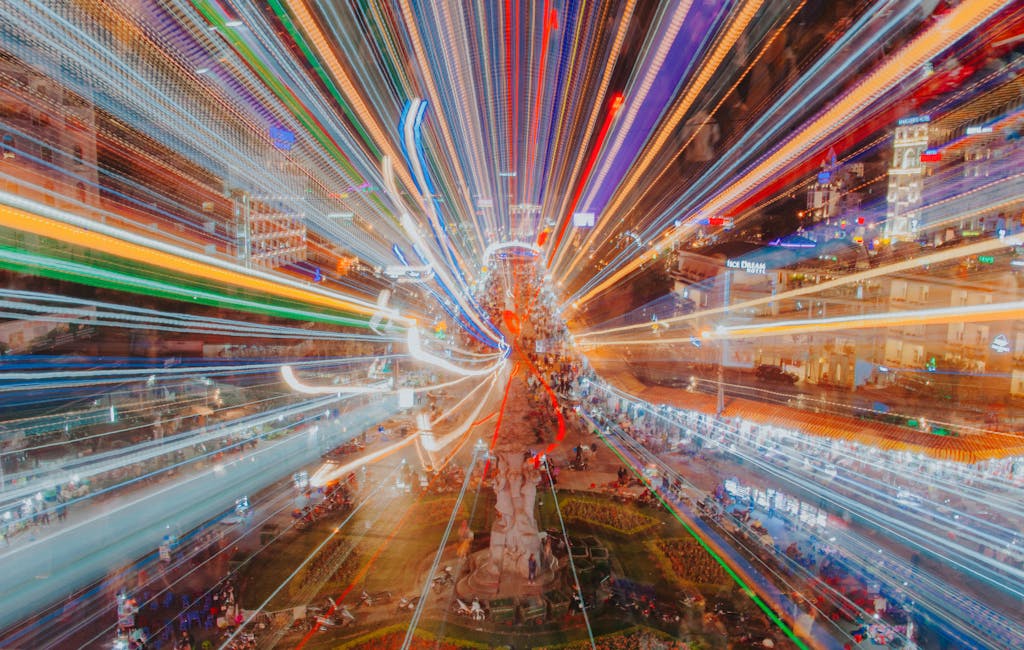 Dynamic urban night scene with vibrant light streaks and long exposure effects on a bustling street.